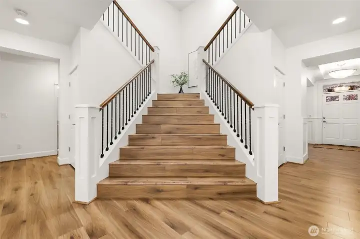 Dramatic formal staircase to the upper level.