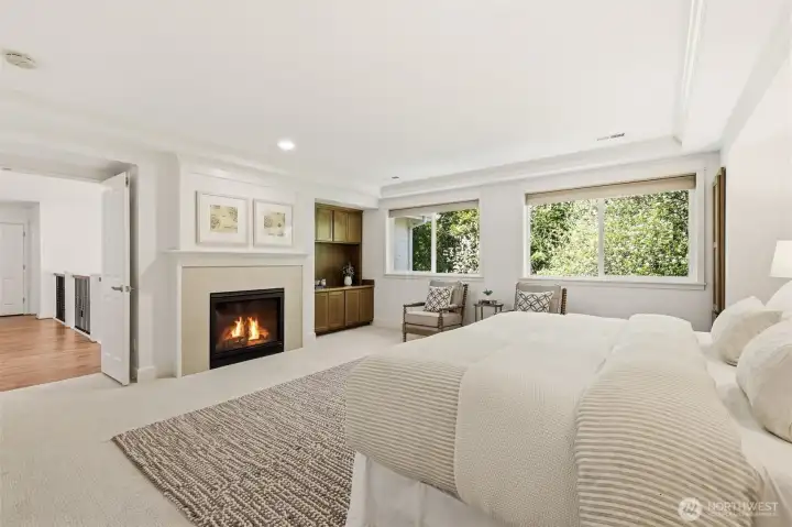 Primary bedroom equipped with cozy fireplace.
