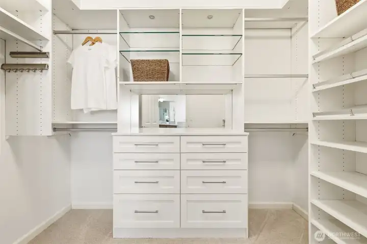 Large primary bedroom walk-in closet with high end California closet type system.