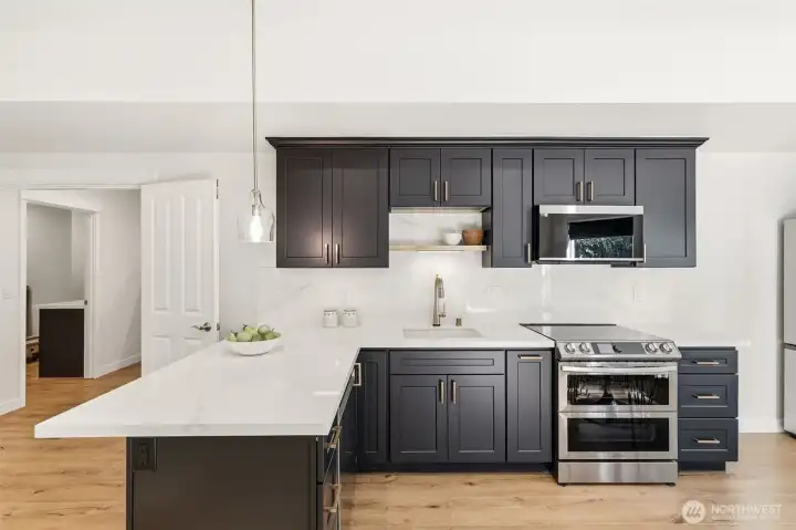 ADU remodel includes quartz countertop with matching backsplash, Samsung stainless appliances.