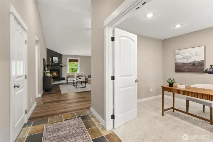 Main floor entry, with stone flooring, and entrance into office, den or craft space. Main floor entry, with stone flooring, and entrance into office, den or craft space.