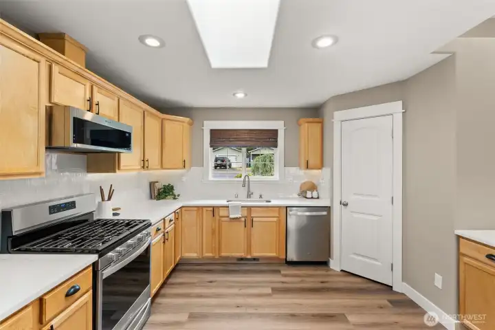 Updated kitchen with quartz counters, walk in pantry, stainless appliances, and new tile backsplash Updated kitchen with quartz counters, walk in pantry, stainless appliances, and new tile backsplash