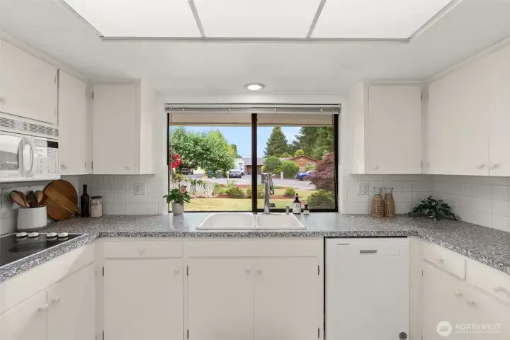 Kitchen with large window looking out to the front of the home. Kitchen with large window looking out to the front of the home.