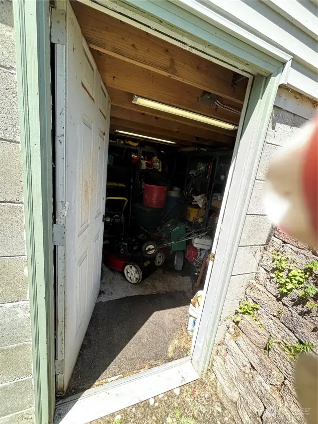 Storage under cute outbuilding for lawn equipment or ?