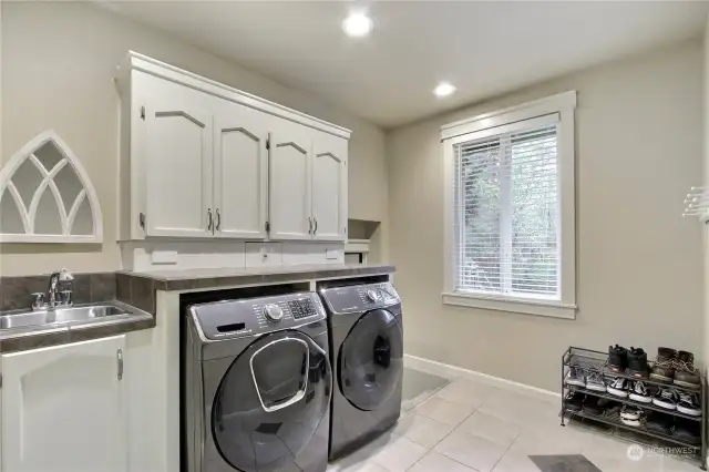 Mud room slash Laundry space complete with Utility sink right of the entrance to the garage.