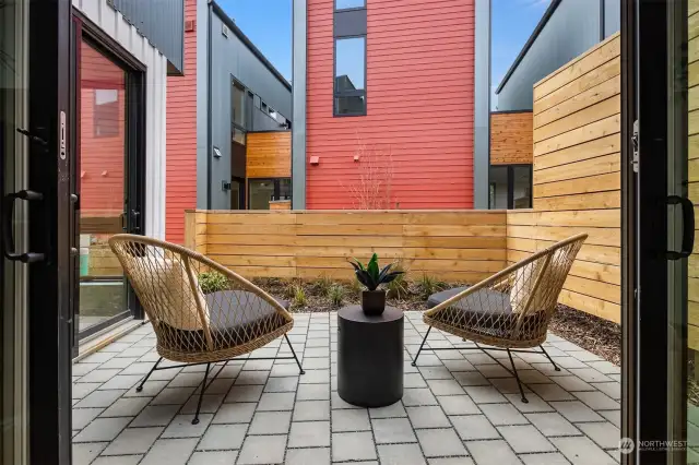 The first of three private outdoor retreats, this front patio is nestled off the dining and living areas, making it the perfect spot for a grill, al fresco dining, or to relax after a long day.