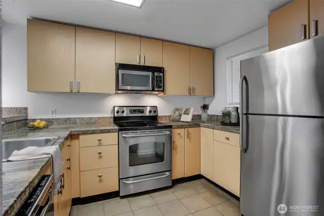 This delightful kitchen has sleek cabinetry, complemented by granite countertops.