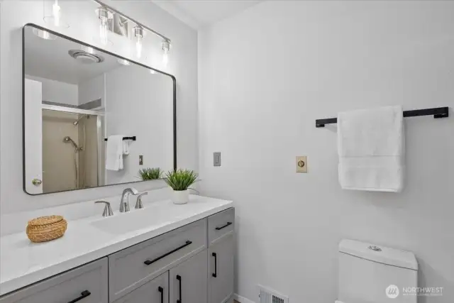 Refreshed bathroom with tub on main floor.