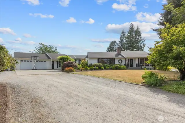 Spacious rambler with daylight basement, mature landscaping and usable acreage!