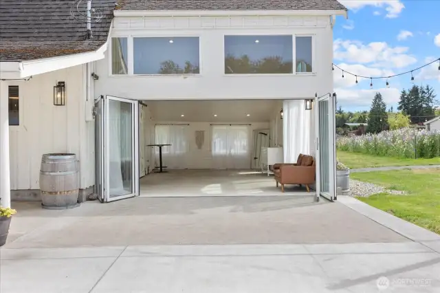 Accordion style glass patio doors for seamless indoor/outdoor flow.