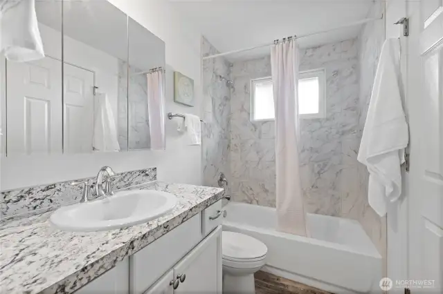 Full/continental 4 piece bathroom with all new fixtures & custom tile surround.