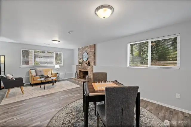 Another view of the family room on the lower level featuring all new LVP flooring, paint and blinds.