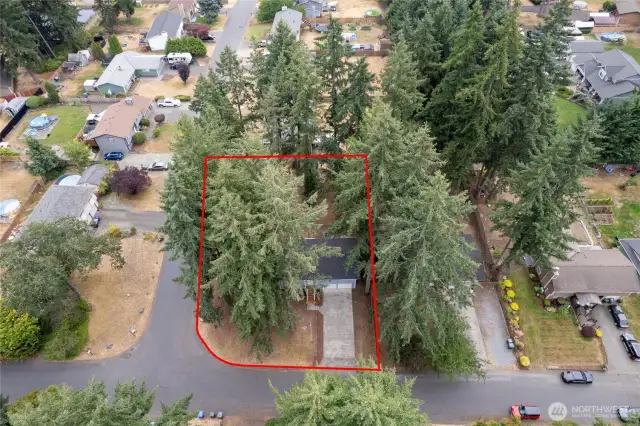 The red border is approximate for this fenced, quarter acre corner lot!