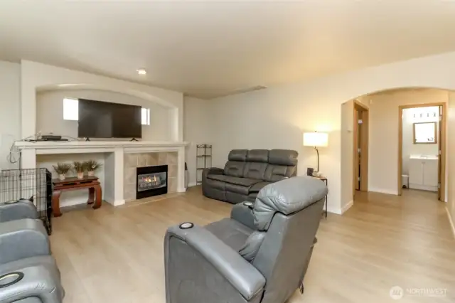 Kitchen opens to Light filled rec room with gas fire place and lovely luxury plank flooring