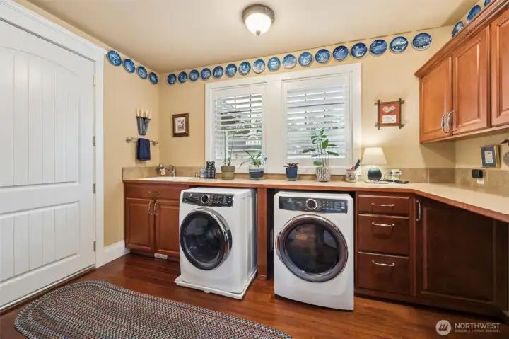 Big utility room with lots of cabinets and countertops + area for racks
