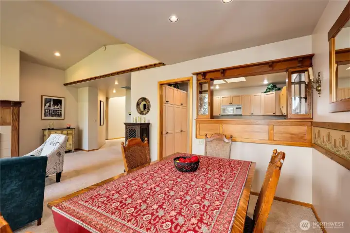 The dining room is adjacent to the kitchen and features a custom wood pass-through.