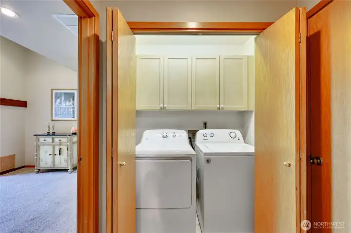 Laundry closet with storage.
