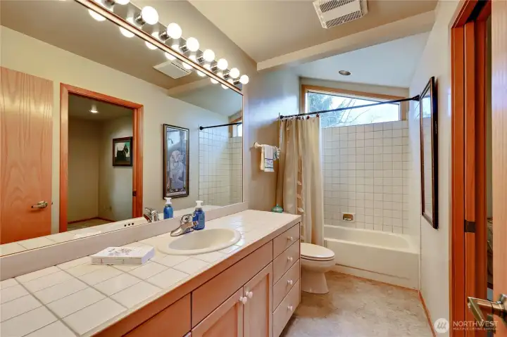 Second bathroom with tub/shower combination and great light.