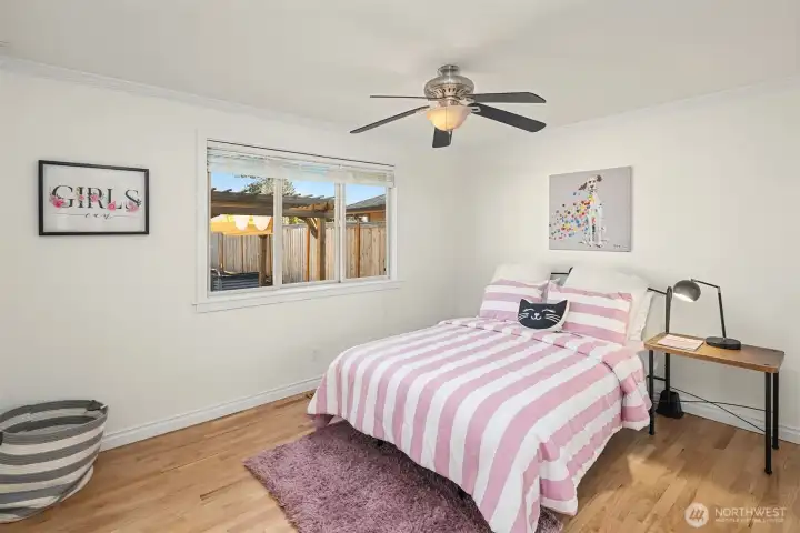 One of three bedrooms on one side of the house. Hardwood floors in three of the four bedrooms