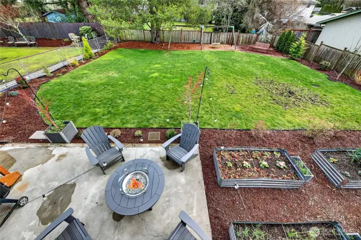 Your view from the upper deck looking to the backyard. Hang spaces, garden beds, and room to run.