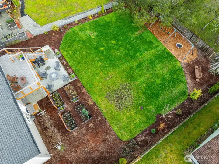Plenty of space to grow the best fruits and vegetables and still have room to play on the swingset and chase the dog and kiddos.