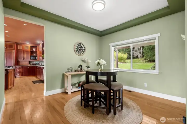 The generous dining room sits adjacent to the kitchen and features 9' ceilings and beautiful views out the th property and pond.