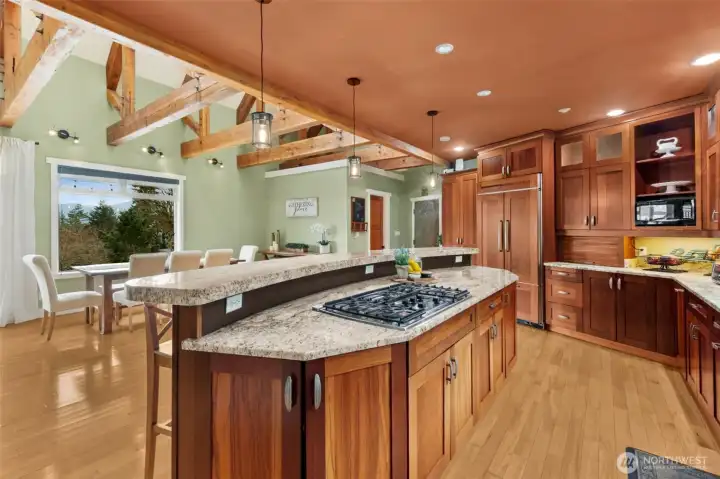 Built in Kitchen aid Refrigerator with frameless, Brazilian Cherry Cabinetry. Expansive island with seating for 6.