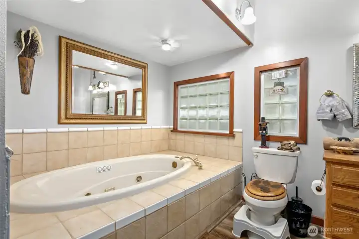 This is the Large bathroom located downstairs on the main floor has a soaking tub, vanity & shower ect.