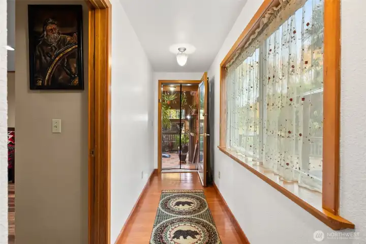 this is the hallway downstairs from the front entry landing when you make a left will lead to the second bedroom downstairs and the solarium that has the hot tub.