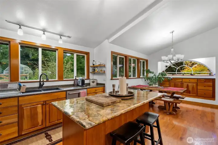 Vaulted ceilings in the Kitchen and dining room and so much natural lighting  including a lovely island to prep food and entertain guest
