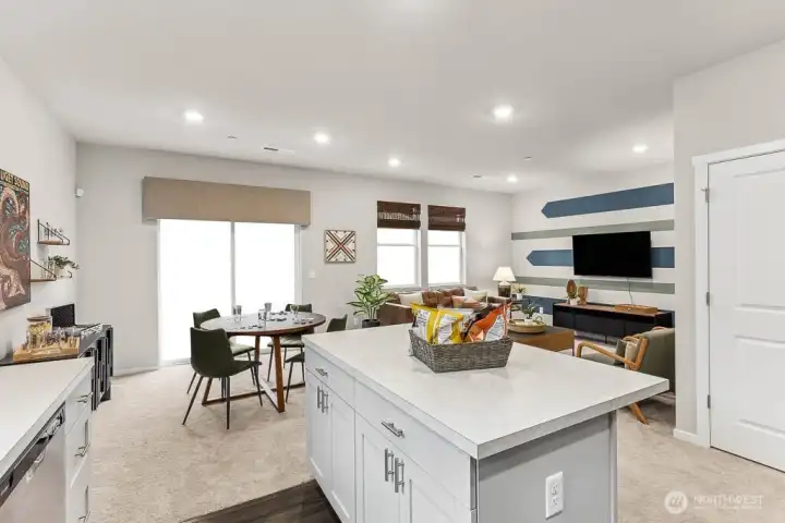 Wide angle to show kitchen, dining and great room space perfect for entertaining. Photos are representative only and may display different color package and/or upgrades.