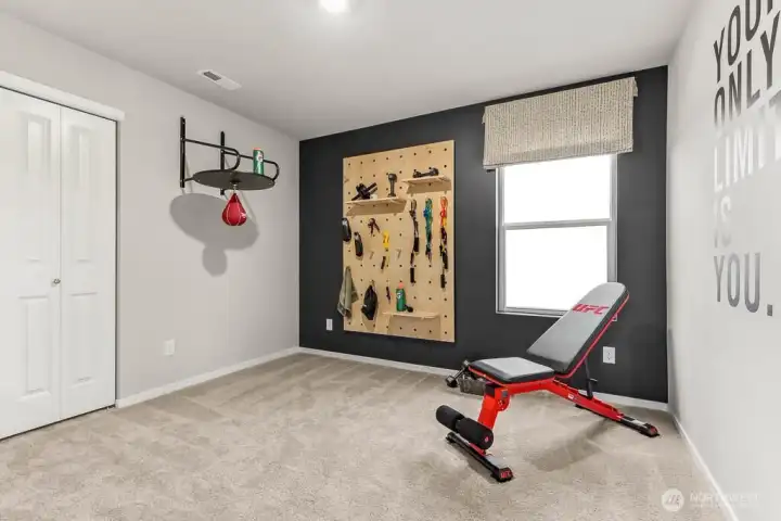 Guest bedroom utilized as a workout space showing the versatility of this floorplan. Photos are representative only and may display different color package and/or upgrades.