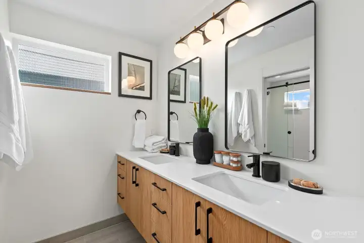 Well-appointed primary bathroom with dual sinks and plenty of storage. Well-appointed primary bathroom with dual sinks and plenty of storage.