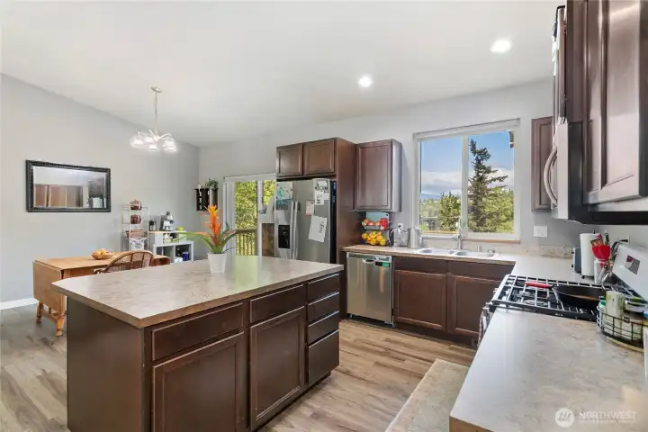 Main floor common area & kitchen w/ vaulted ceilings