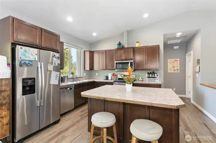Main floor common area & kitchen w/ vaulted ceilings