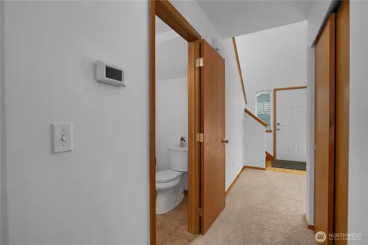 Hallway to powder room leads between the entryway to the greatroom Hallway to powder room leads between the entryway to the greatroom
