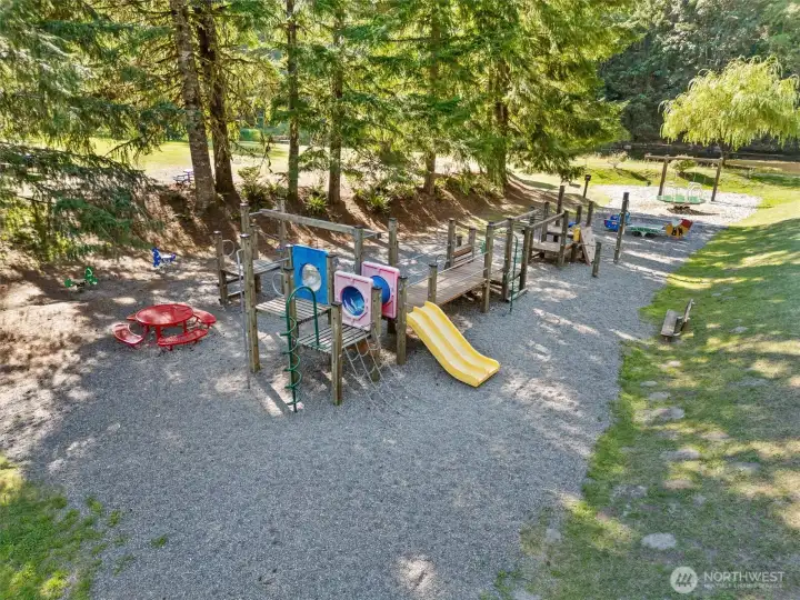 Neighborhood playground set among the trees.