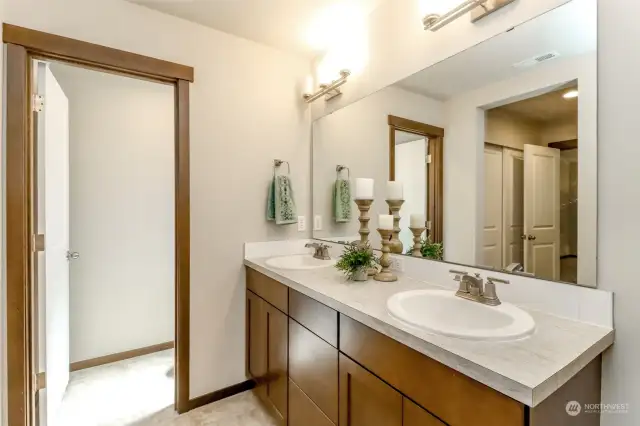The primary bathroom suite features a double vanity and water closet.