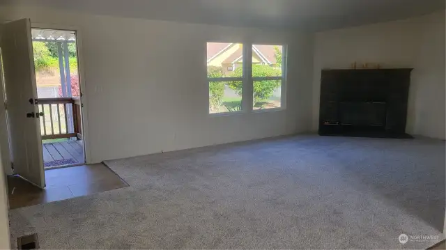 Living room with wood burning fireplace.