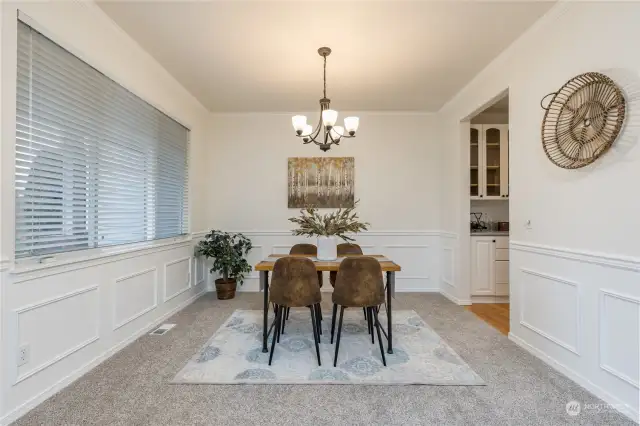 Formal dining room with a butler's pantry leading to the kitchen