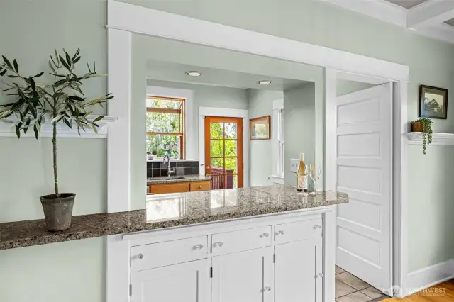 Original Swing door to kitchen and built in cabinets under Isand