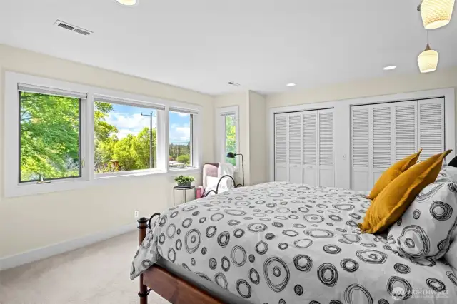 Primary bedroom with plenty of windows and two large closets