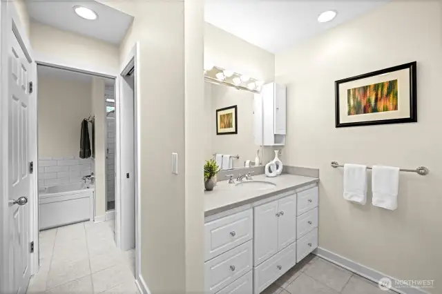 Separate vanities with Corian countertops
