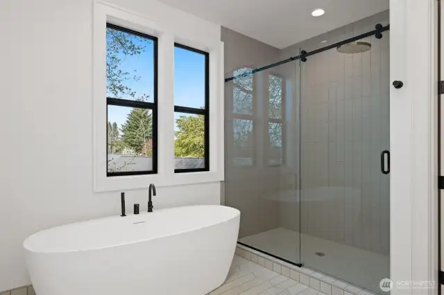 Deep free-standing soaker tub and spacious fully tiled shower