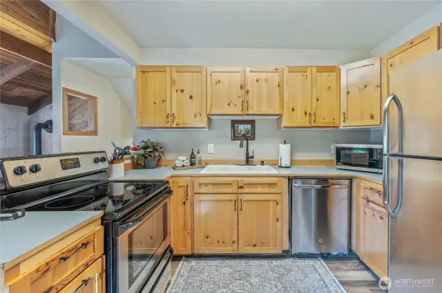 Modern kitchen with stainless steel appliances included for your convenience.