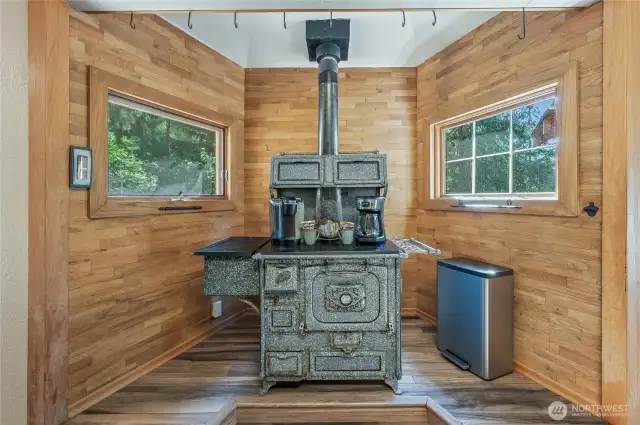 Unique antique wood stove used as storage adds character to the kitchen space.