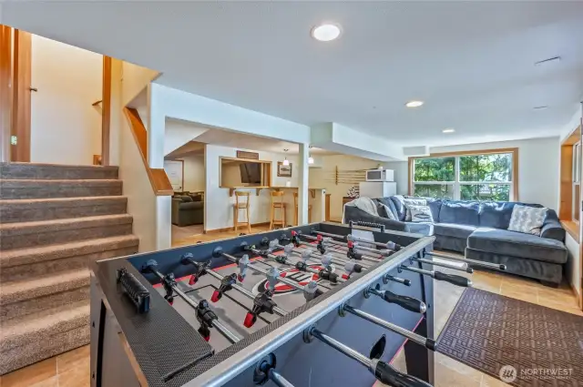 Entertainment ready: game area, media lounge, and kitchenette for guests or gatherings.