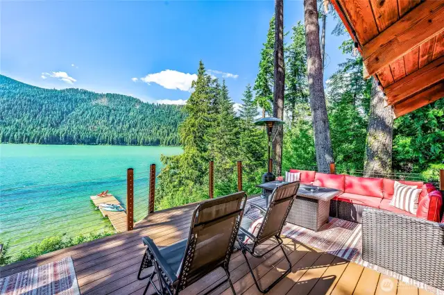 Outdoor living at its best with multiple seating areas and panoramic waterfront views.
