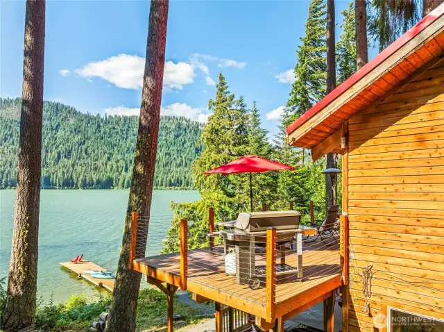 Corner deck perspective with Fish Lake sparkling behind—perfect for morning coffee or evening wine.