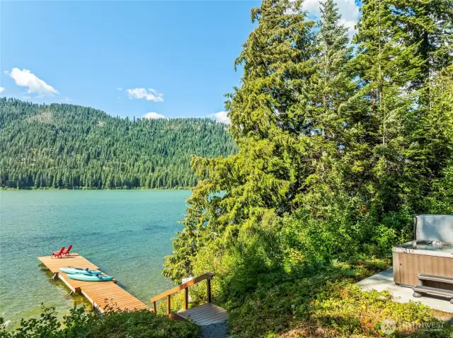Relaxing hot tub with views of the private dock and shimmering Fish Lake in the distance